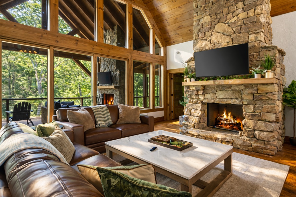 Enjoy breathtaking views of the surrounding woods from the comfort of the main living room&rsquo;s plush seating.
*Indoor Fireplace (Seasonal Use October - April)