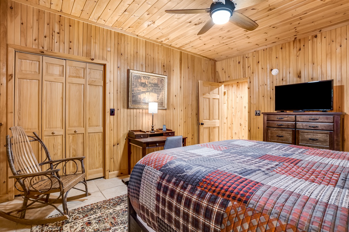 Queen bed with a Tv and large dresser