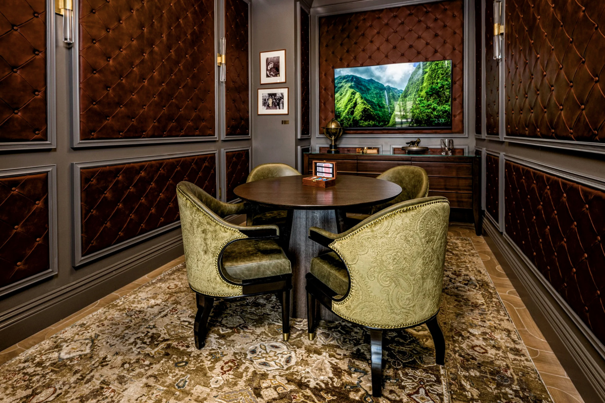 A private dining room finished in warm wood and emerald velvet - reserve it for intimate dinners and celebrations.