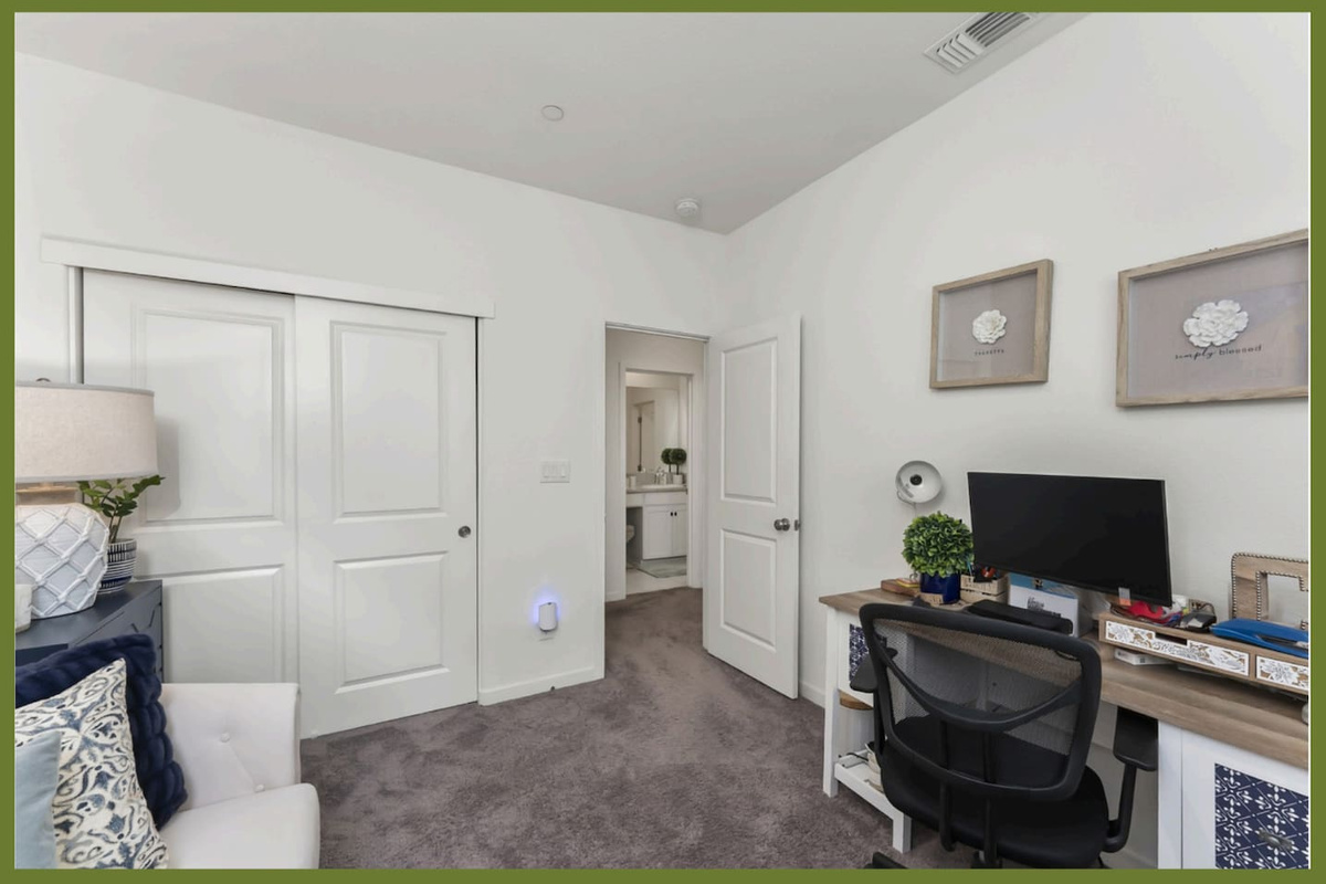 Office with desk workspace, TV, closet storage, and a twin sleeper chair that converts into an extra bed.