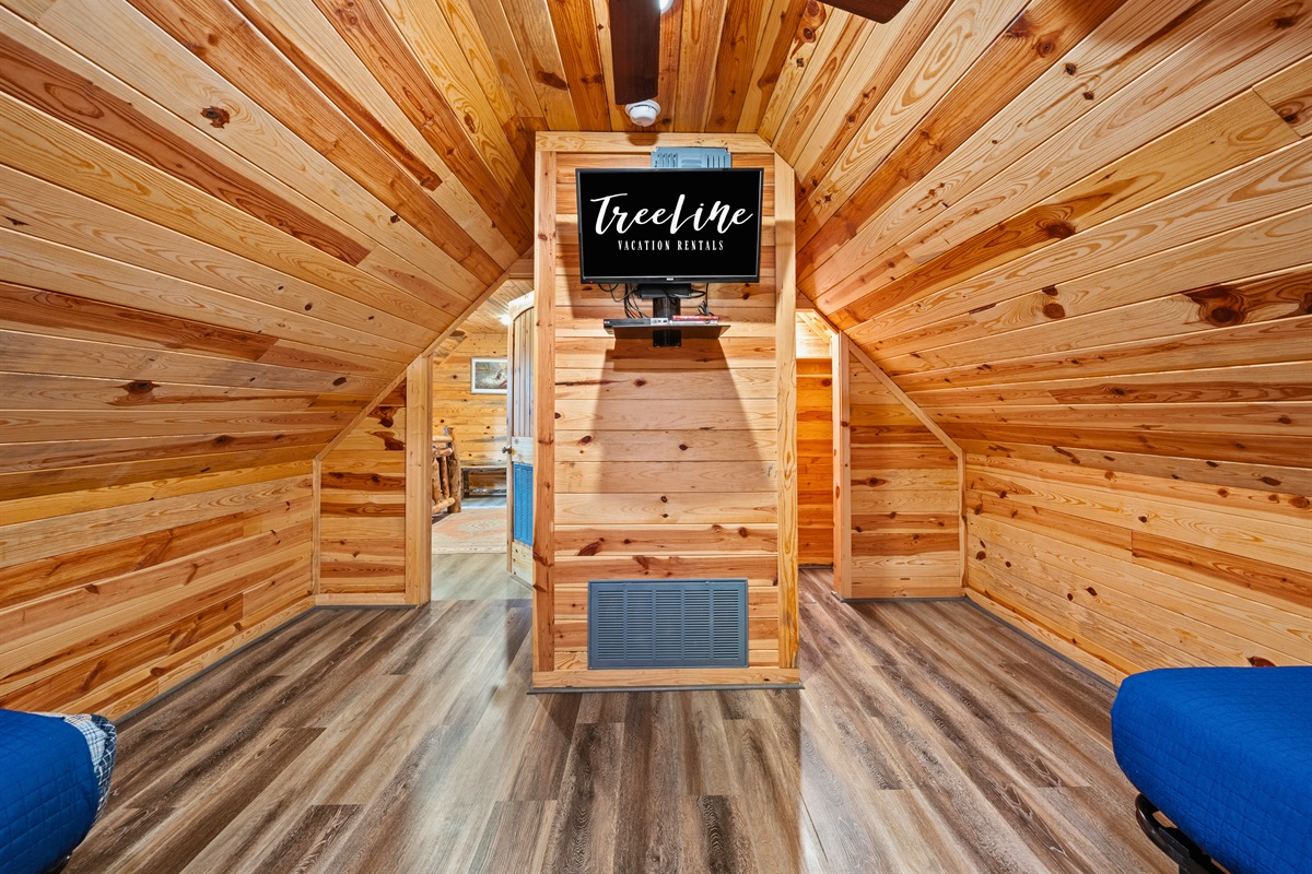 This loft-style sleeping space feels cozy and comfortable while still offering plenty of room for kids or extra guests.