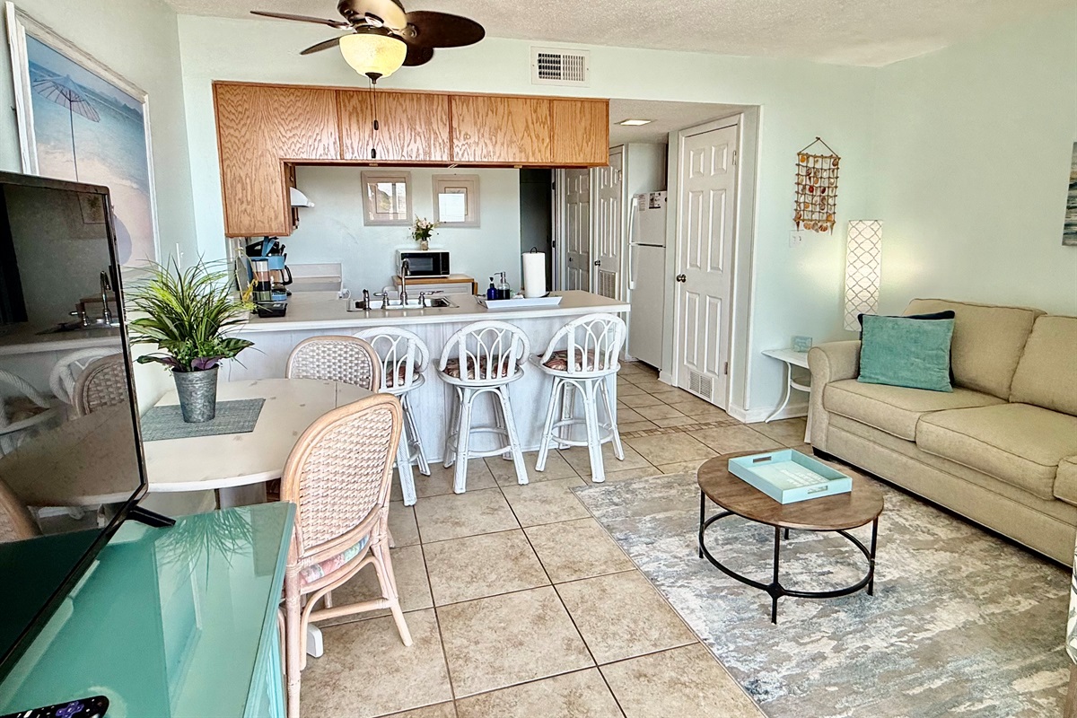 Seating for 5 at the dining table and kitchen bar.