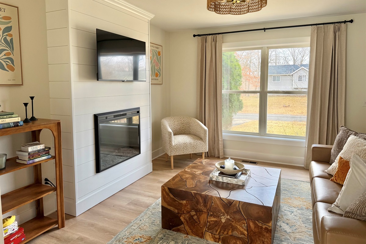 Bright, inviting living space with abundant natural light, a modern fireplace, and comfortable seating. The perfect place to relax and unwind after a day out
