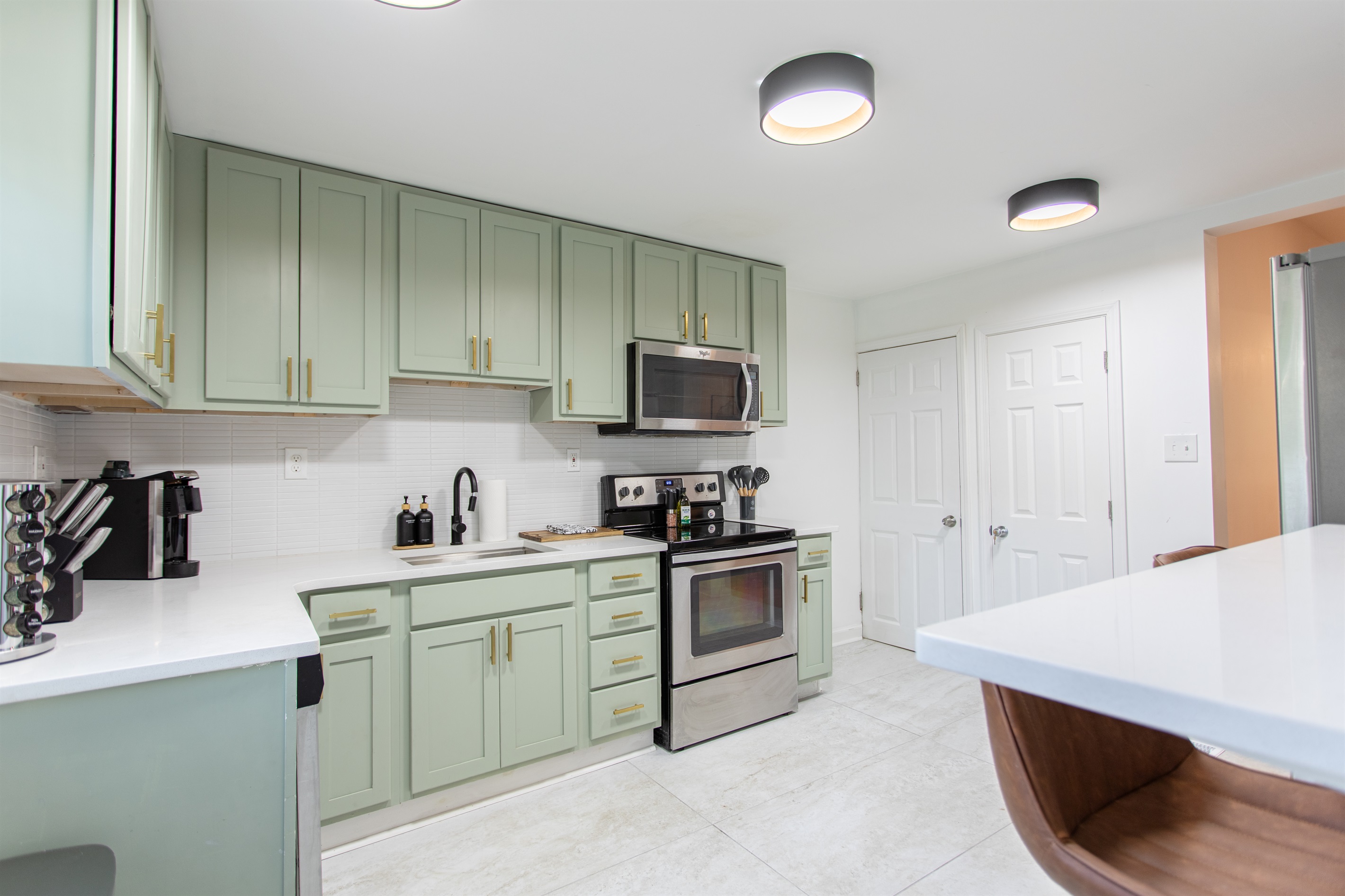 Spacious full kitchen featuring stainless steel and modern appliances.