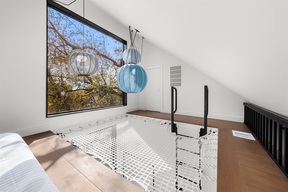 A one-of-a-kind loft sleeping net bathed in natural light—perfect for kids or adventurous guests looking for a fun and memorable place to relax.
