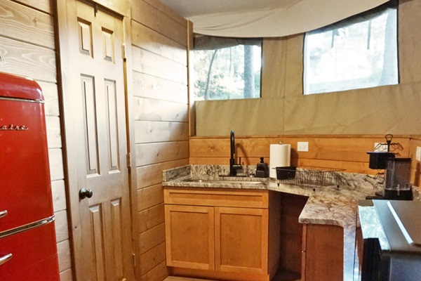 Retro vibes with a red fridge and scenic views—perfect for culinary adventures!