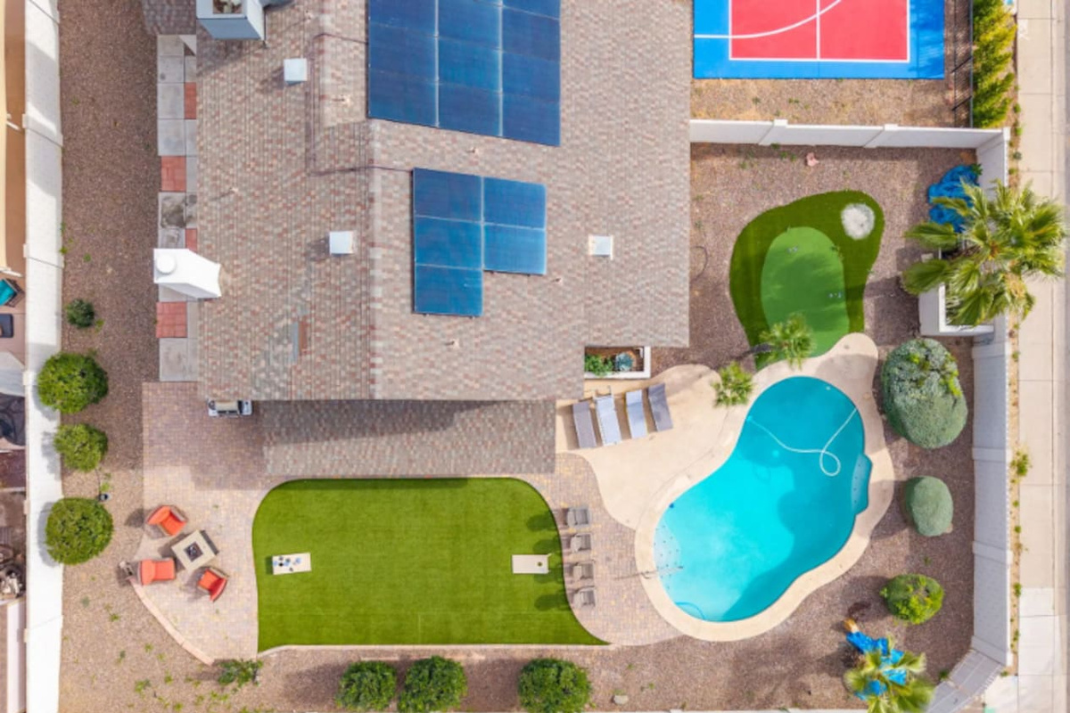 Urban backyard retreat with resort pool, sports court, putting green, and expansive lawn.