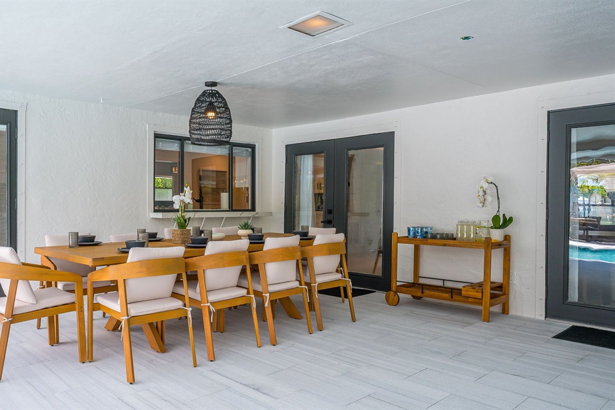 Designed for luxury and comfort, this outdoor space invites you to dine, relax, and unwind in true resort fashion. Enjoy poolside loungers, shaded patio seating, and an ambiance that blends modern elegance with the ease of Florida living