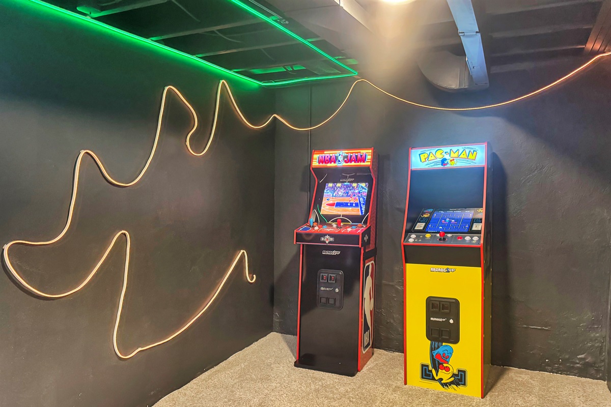 Game on! Arcade area with classic games and vibrant neon ambiance.