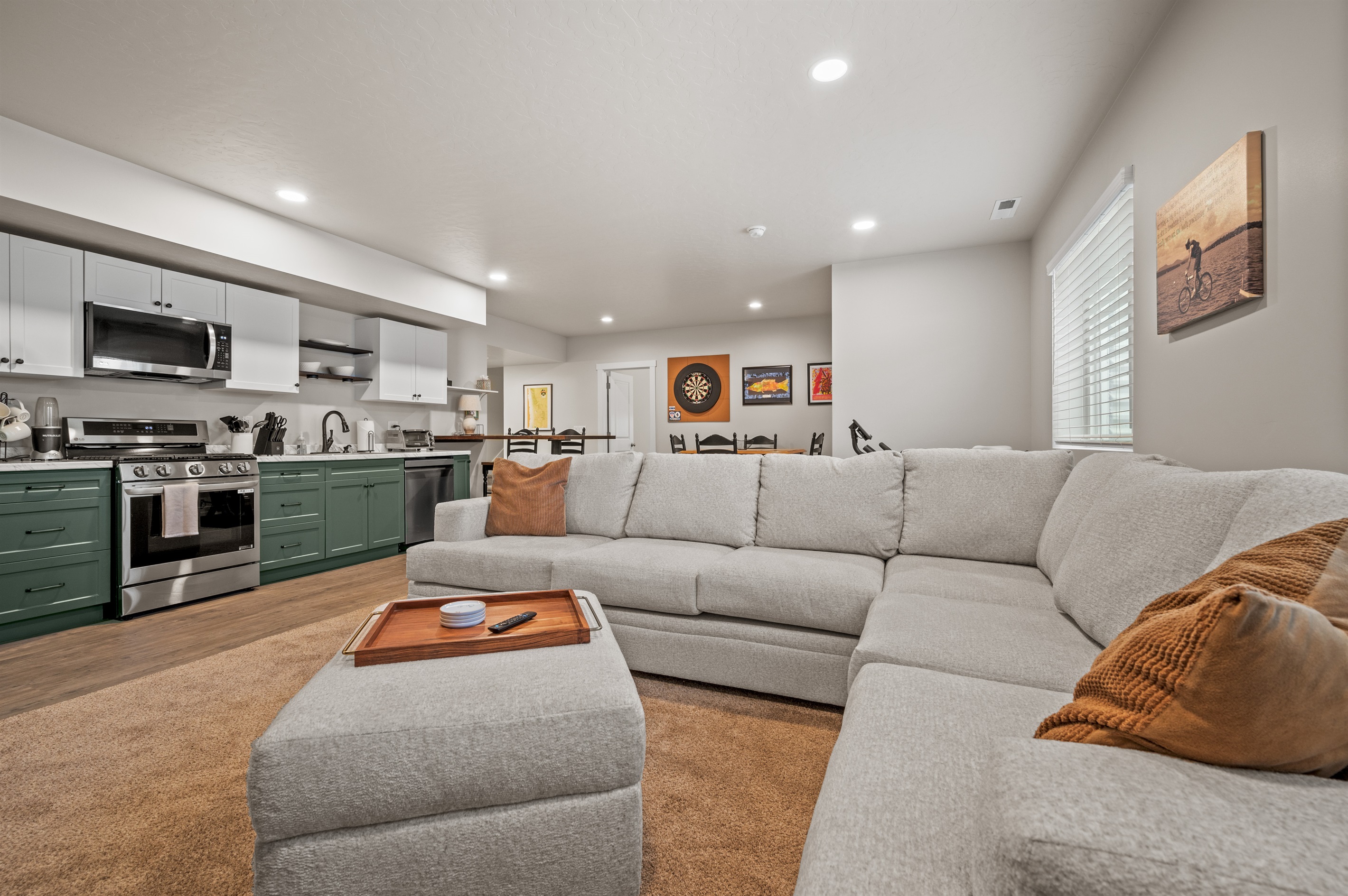 Relax on the large sectional with ottoman in this open-concept living space that connects effortlessly to the kitchen and dining areas.