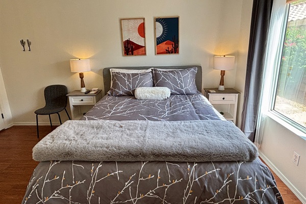 Queen bedroom on main floor with 55" Smart Tv and blackout curtains
