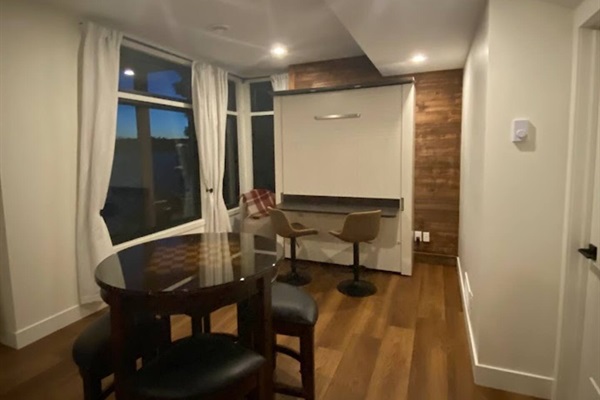 Lower level workspace against collapsed murphy bed