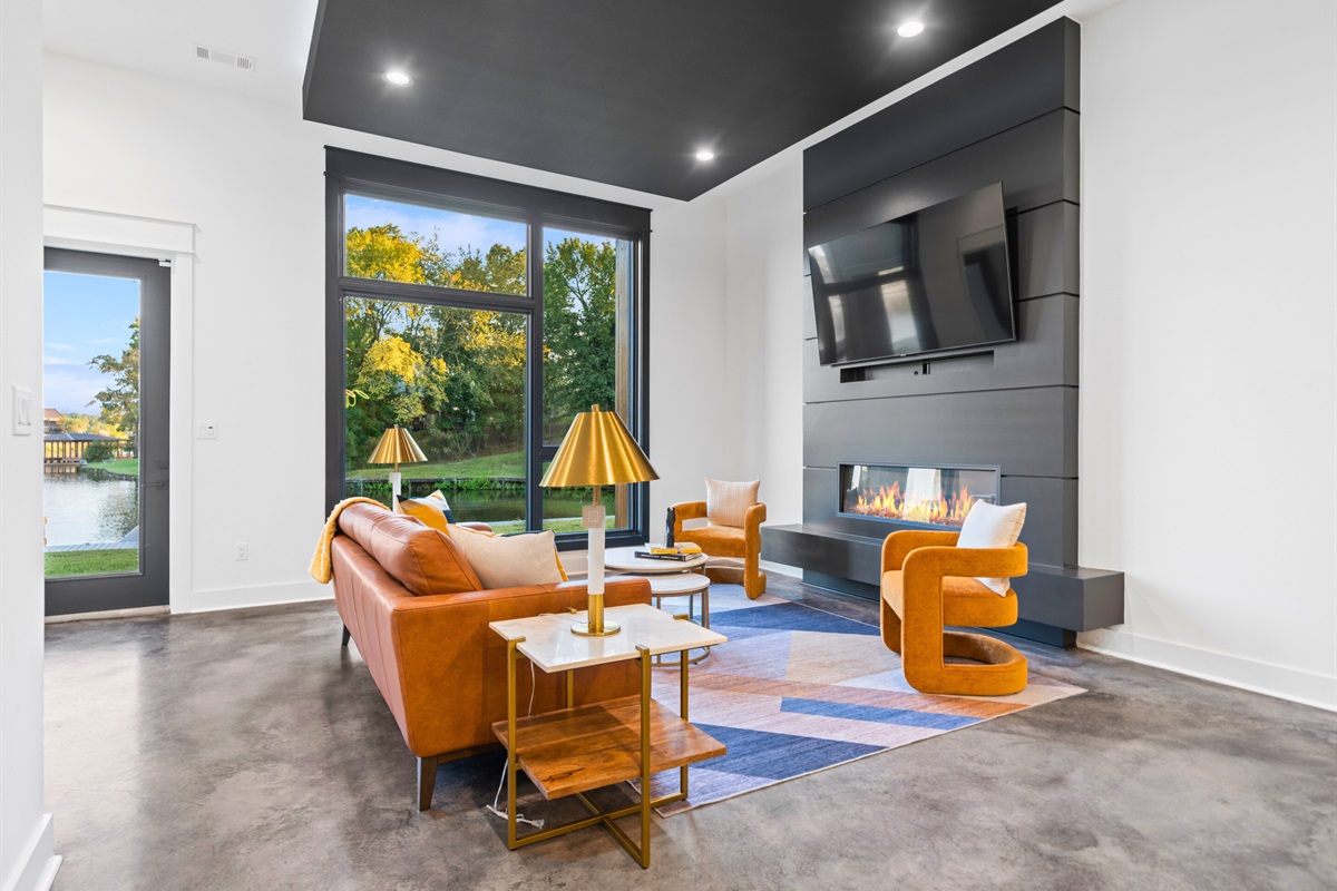 Bright and spacious, this living area features large windows, stylish decor, and a layout that encourages relaxation and conversation.