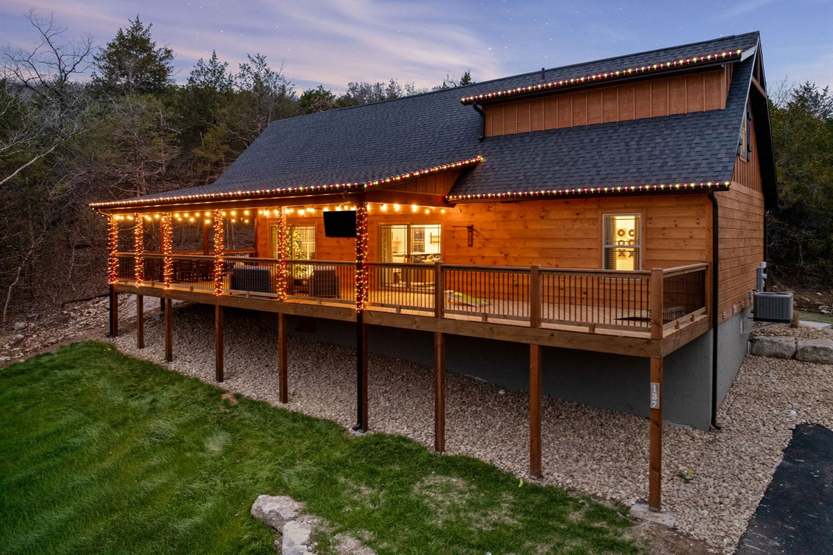 Evening glow highlights the cabin’s large deck and outdoor space.