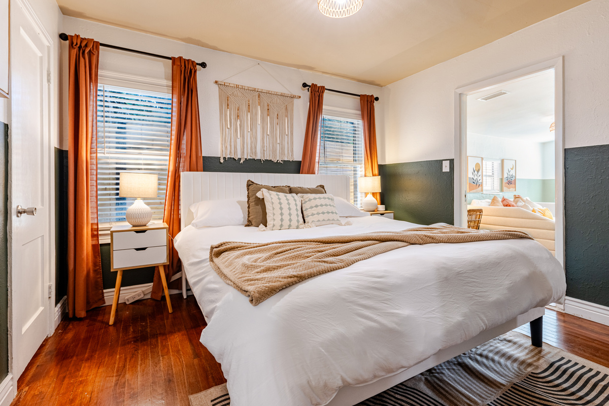 Unwind in a sunlit space with plush bedding and modern decor!
