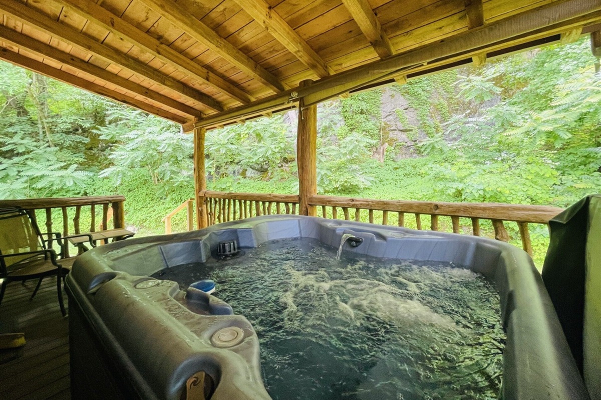 Private hot tub on back porch of the cabin