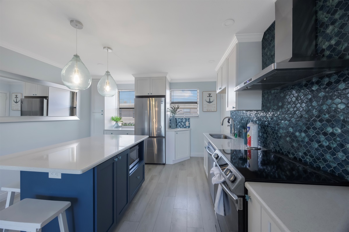 Kitchen stocked with cooking/eating/drinking utensils