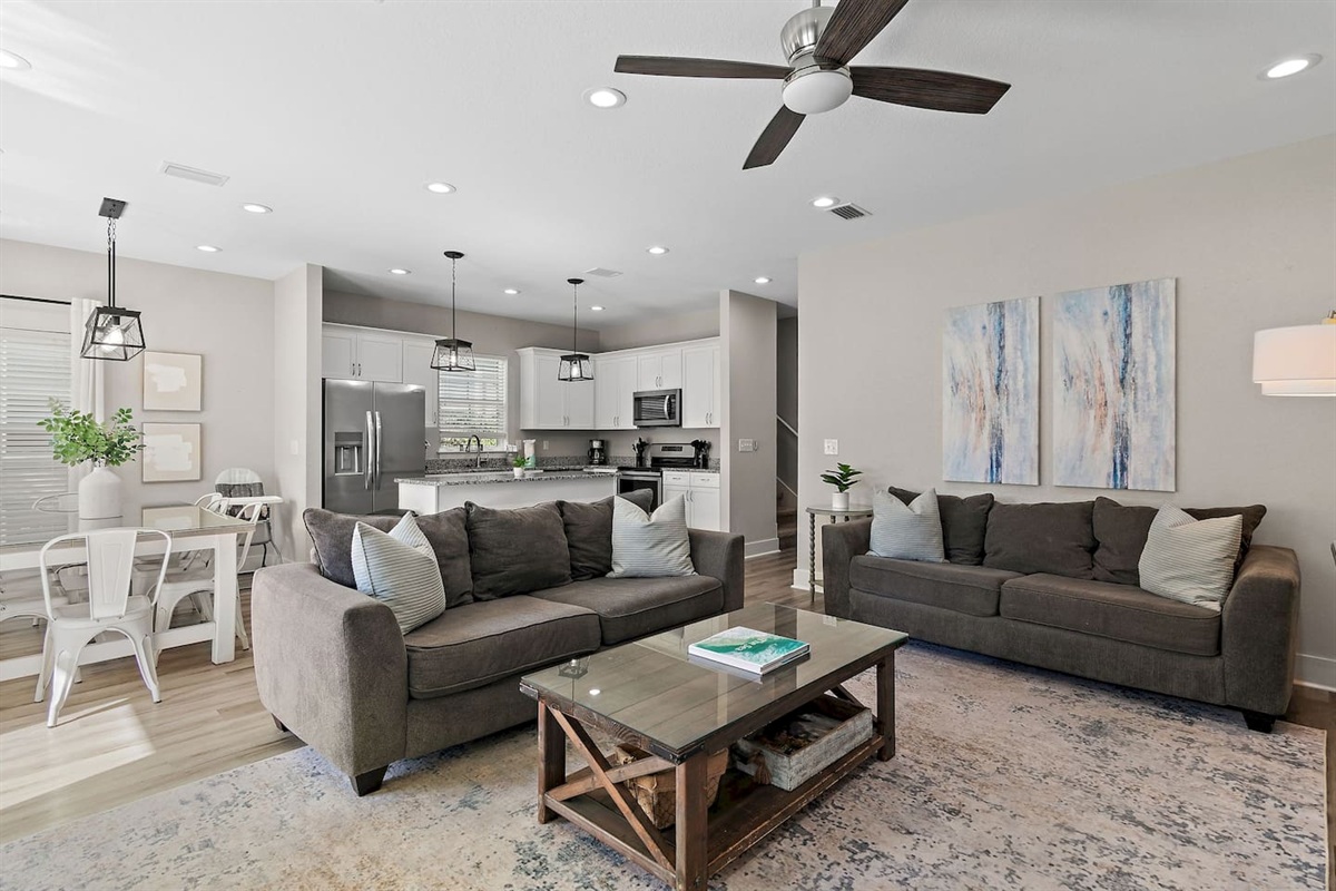 The open-concept living area includes a kitchen island, dining space, and kitchen.