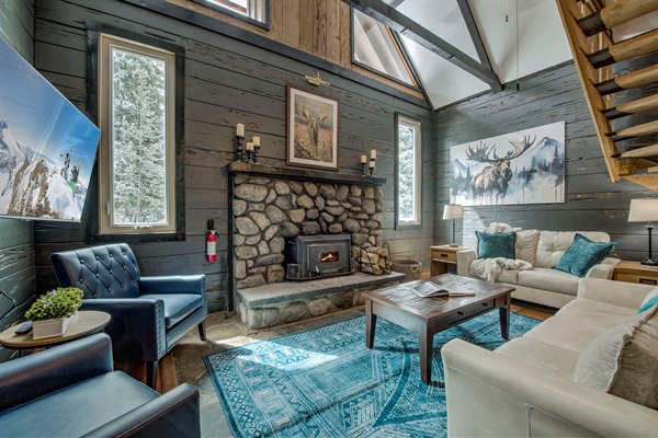 Cozy up by your stone fireplace—soaring ceilings, warm textures, and inviting seating create the perfect space for you to unwind and make it yours.