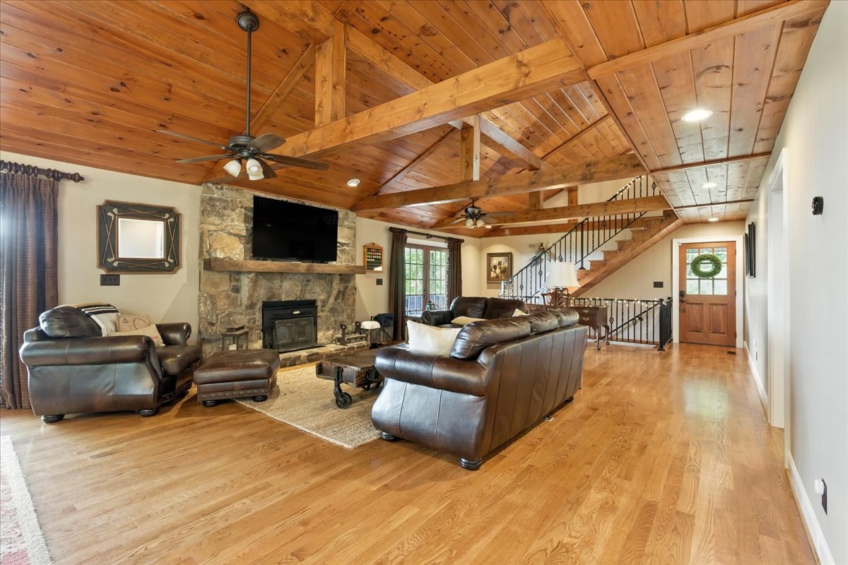 the living room is furnished with comfortable leather sofas and armchairs, providing a cozy and inviting atmosphere.