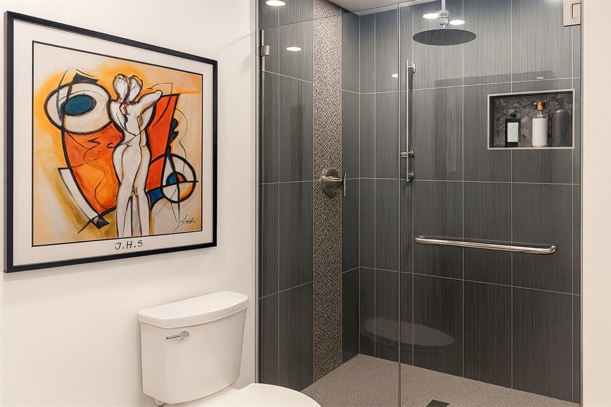 Full shared bathroom with spacious walk-in shower and modern tile, used only by guests in The Gold Room and the on-site hosts at Garden of Manors.
