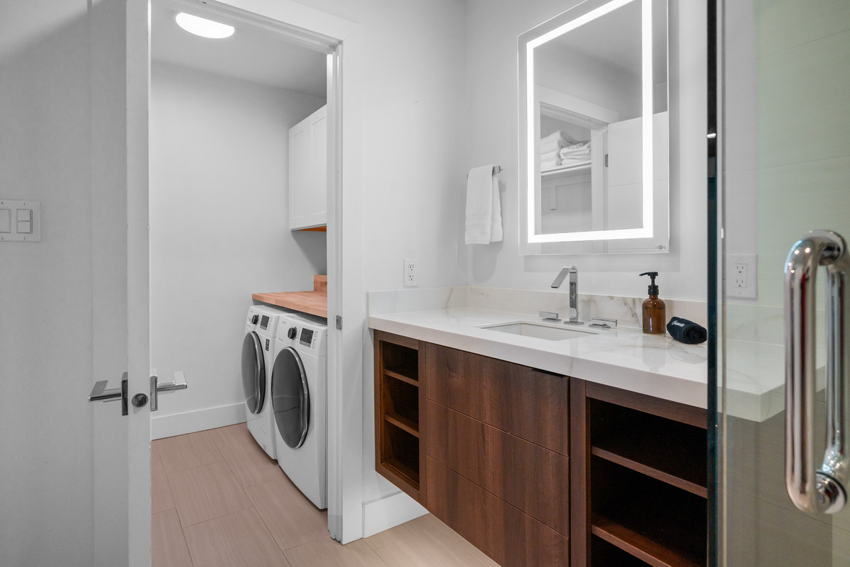 Primary ensuite bathroom featuring a large vanity and modern finishes.