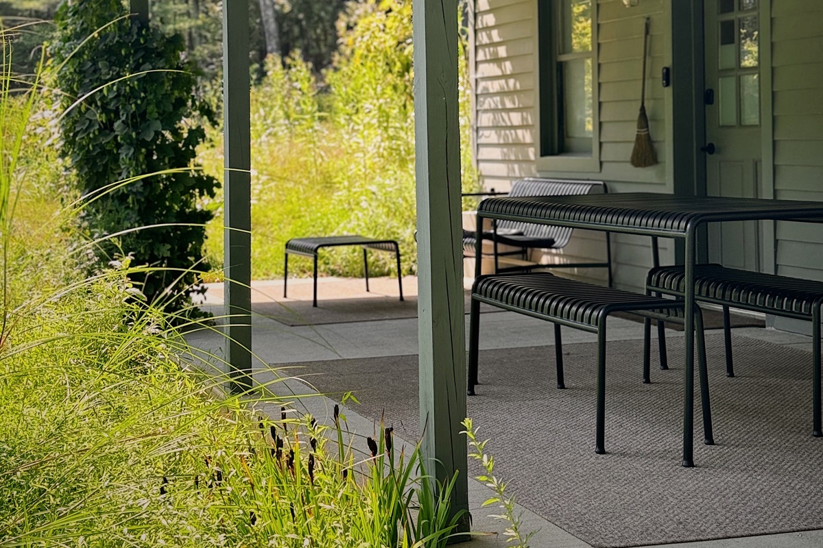 Lounge seating and outdoor dining surrounded by hops and sage.