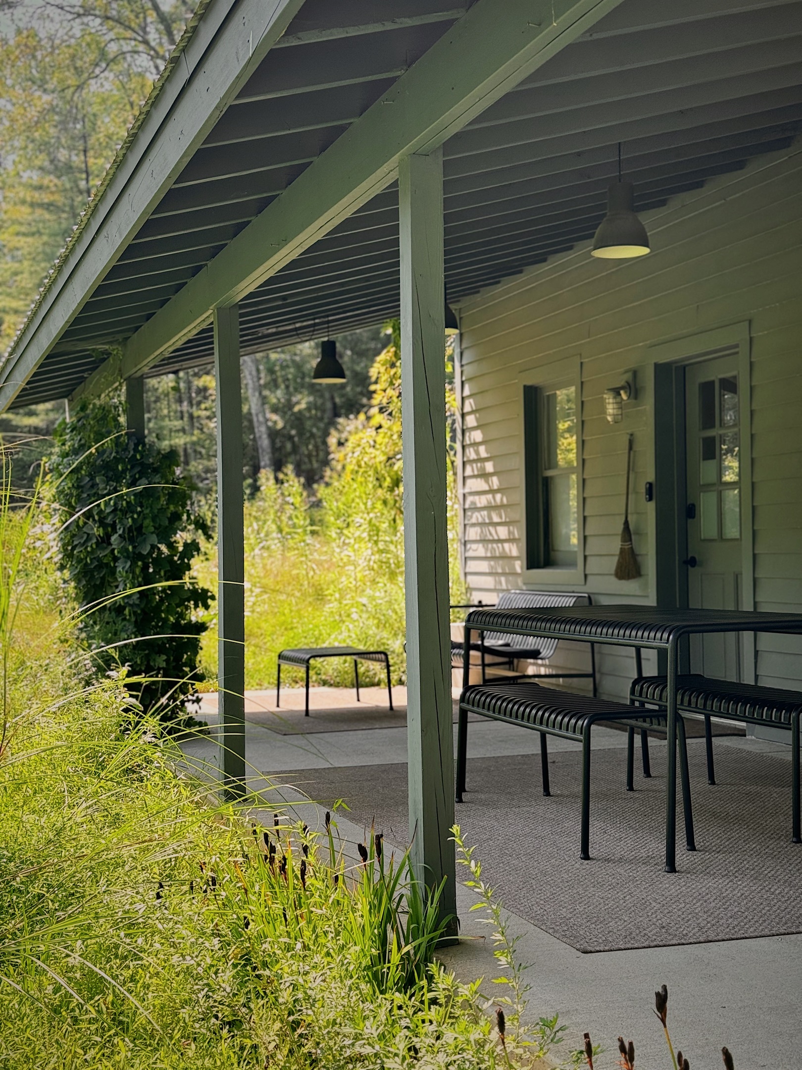 Lounge seating and outdoor dining surrounded by hops and sage.