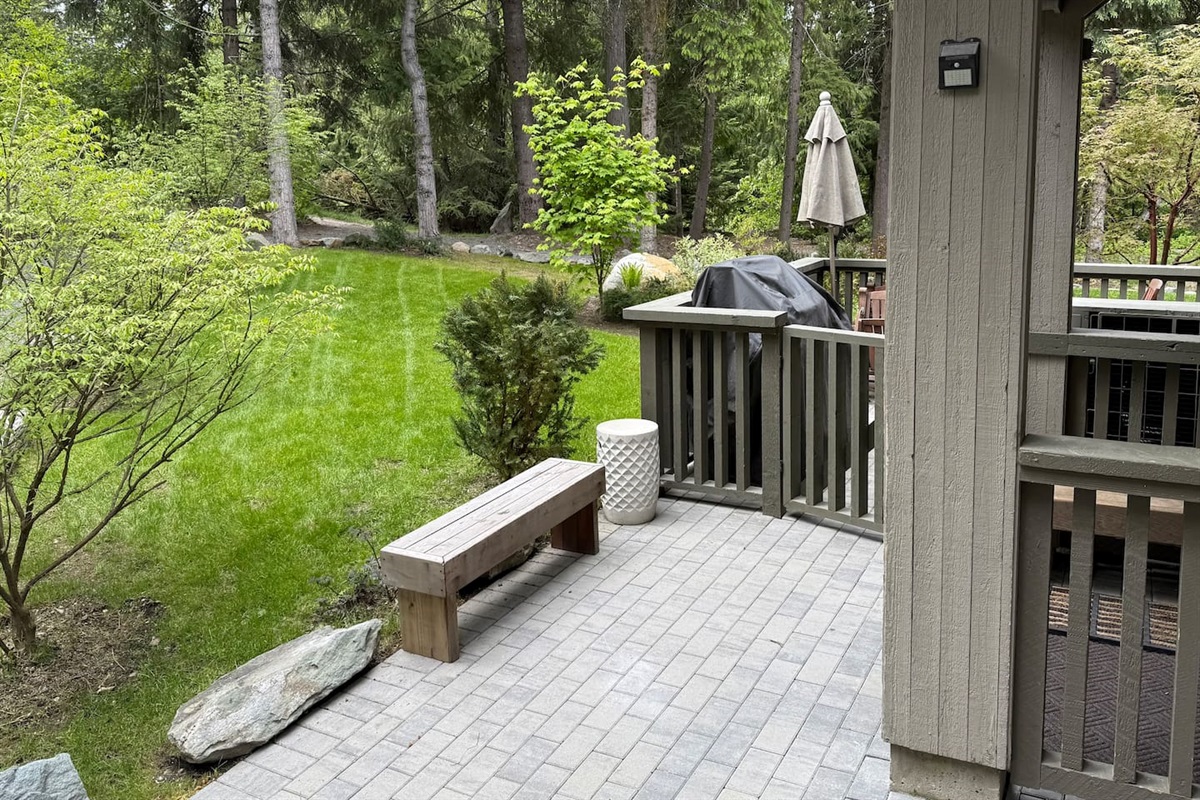 Backyard enclosed patio w/BBQ (summers only) and an extended lawn area where the kids can play. 
