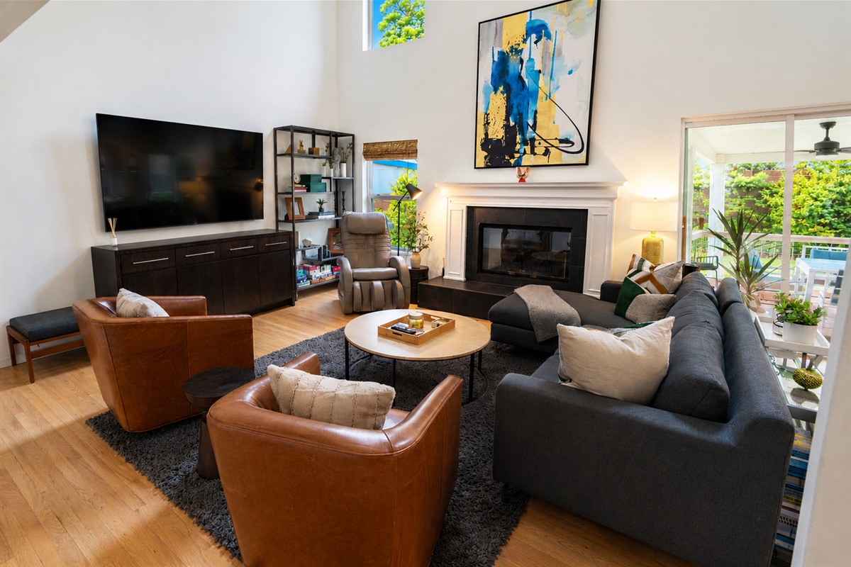 Living area with smart tv, massage chair and fireplace.