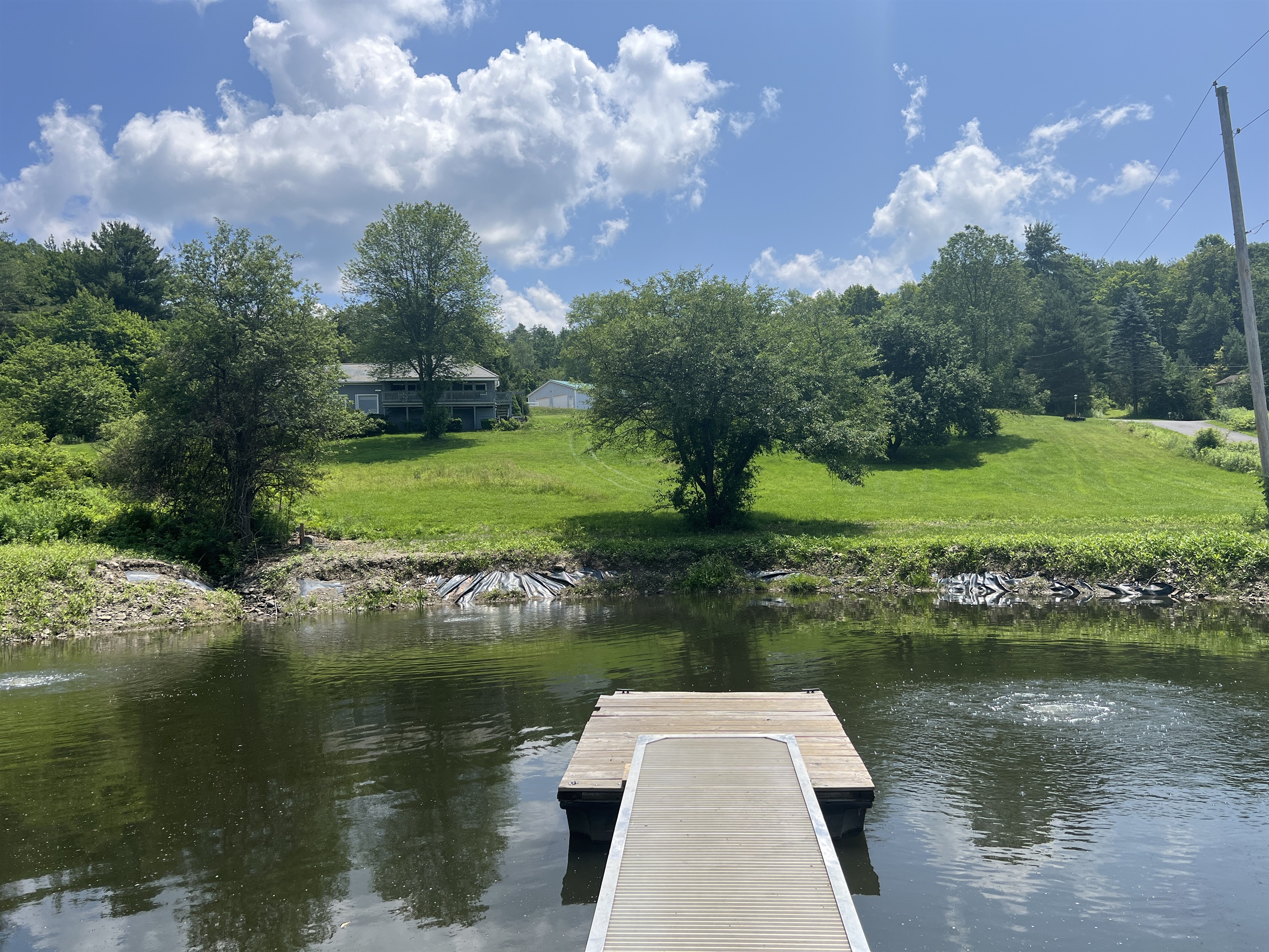 Shagbark Hill private pond with dock, see the house on the hill to the left. NO fishing, please.