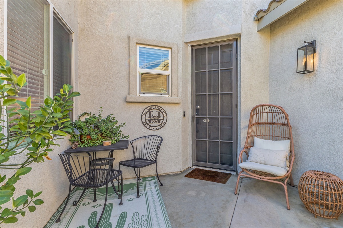 Cozy front patio with stylish seating — the perfect spot for morning coffee or evening relaxation.