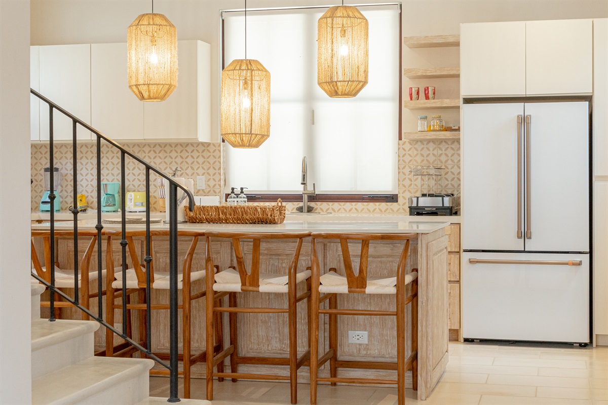Open concept living with kitchen and living area flowing directly to outdoor living and pool area.