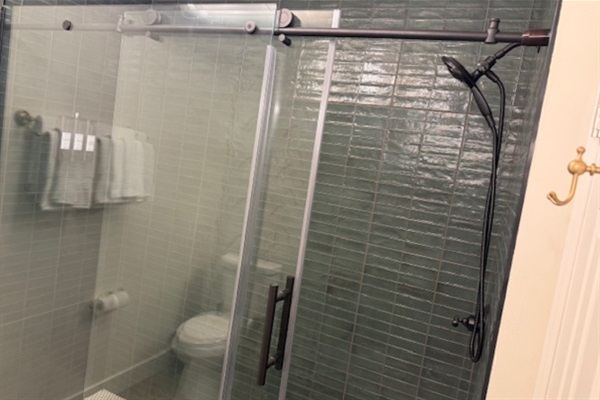 Modern tile shower with clean finishes and reliable hot water for a refreshing, comfortable stay near University of Georgia.
