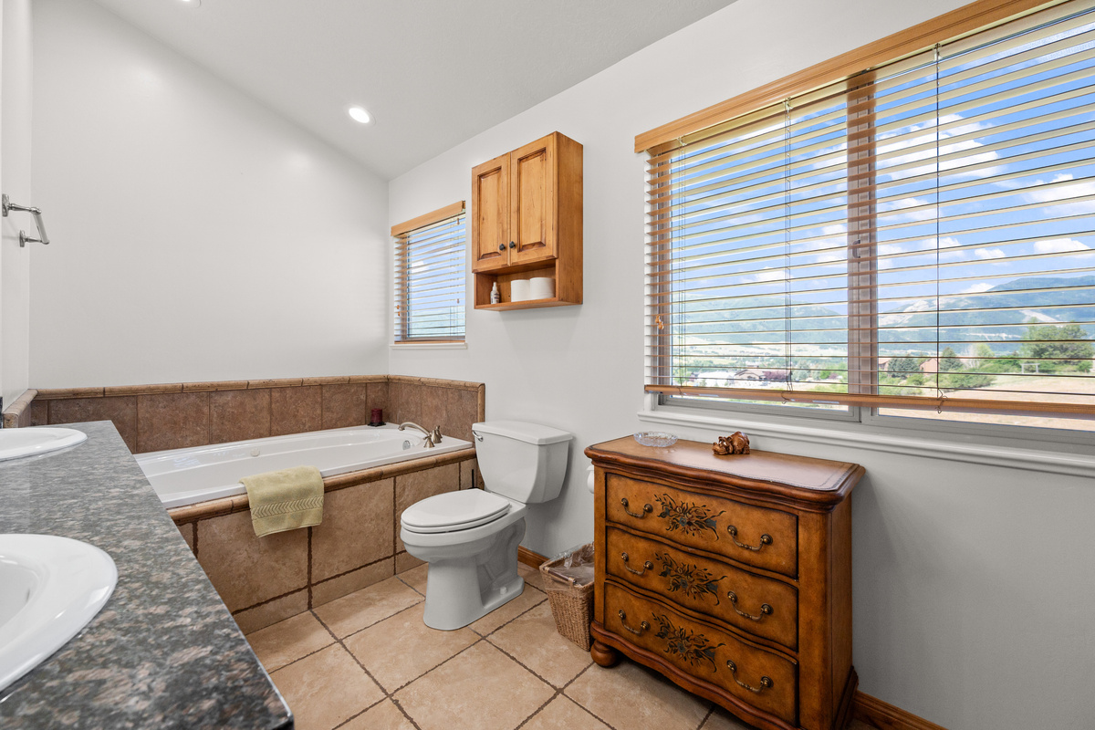 Designed for convenience and ease, the bathroom provides a fresh space to get ready for the day or unwind in the evening with stunning views