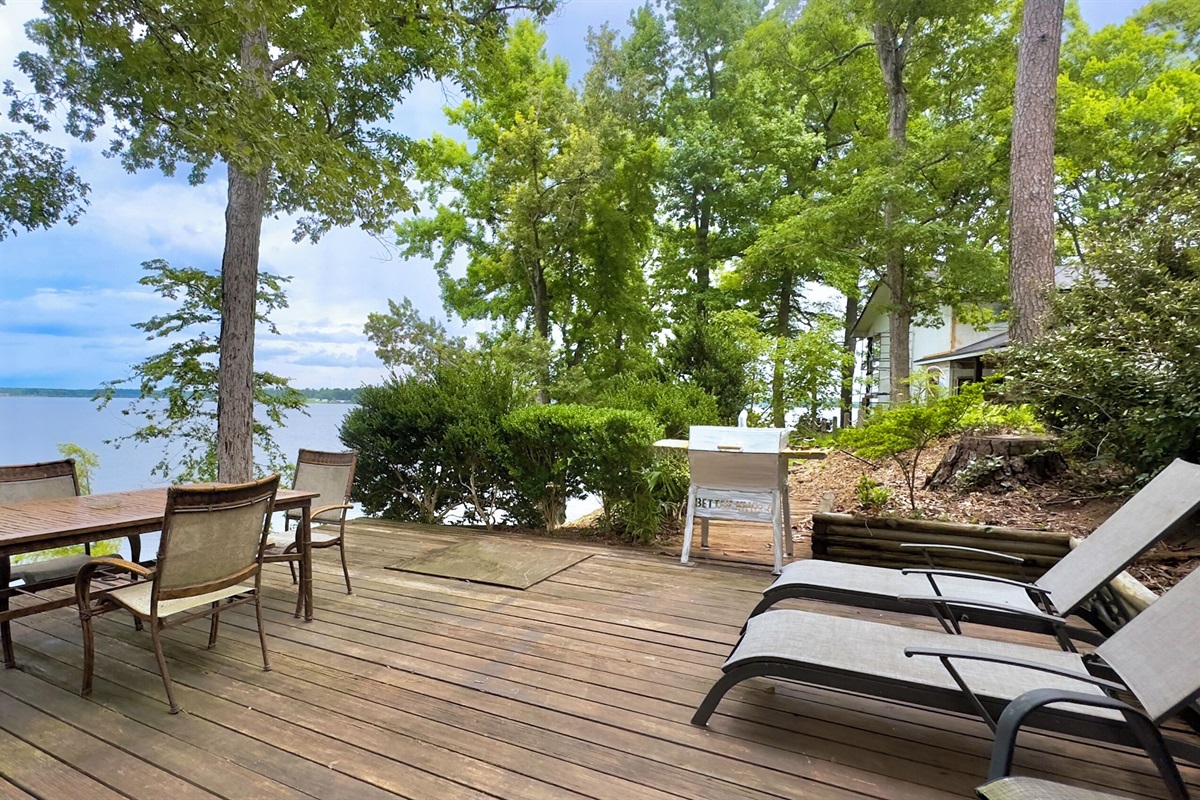 Additional deck area overlooking lake with seating and charcoal grill