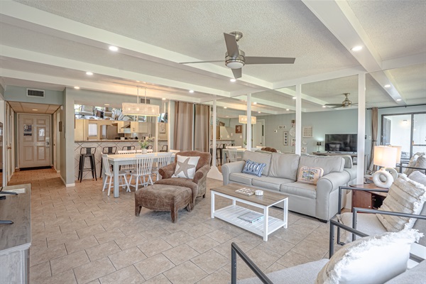Living area with comfy seating, sleeper sofa, ceiling fan and smart TV
