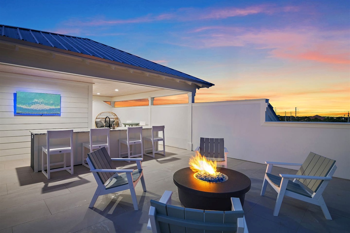 Breathtaking Gulf views from the rooftop, complete with a bar, firepit, and cozy lounges.

