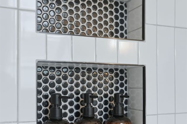 Built-in shower niches stocked with essentials, combining convenience with a sleek, modern design
