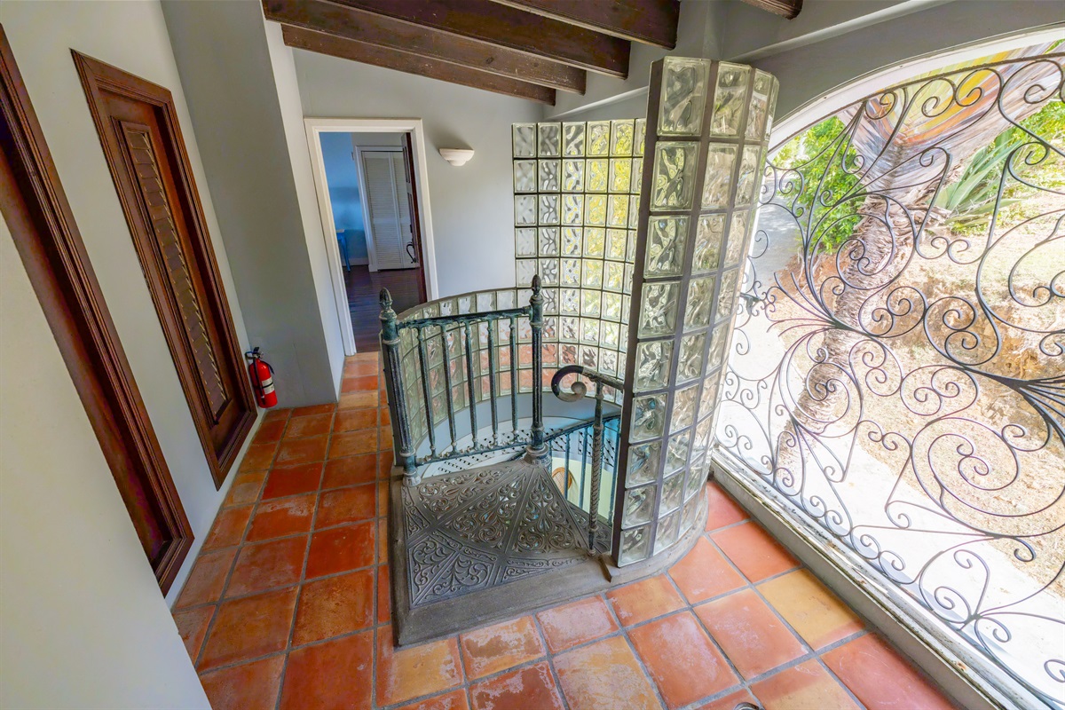 Spiral staircase leads to this gorgeous landing that brings you to two more guest suites