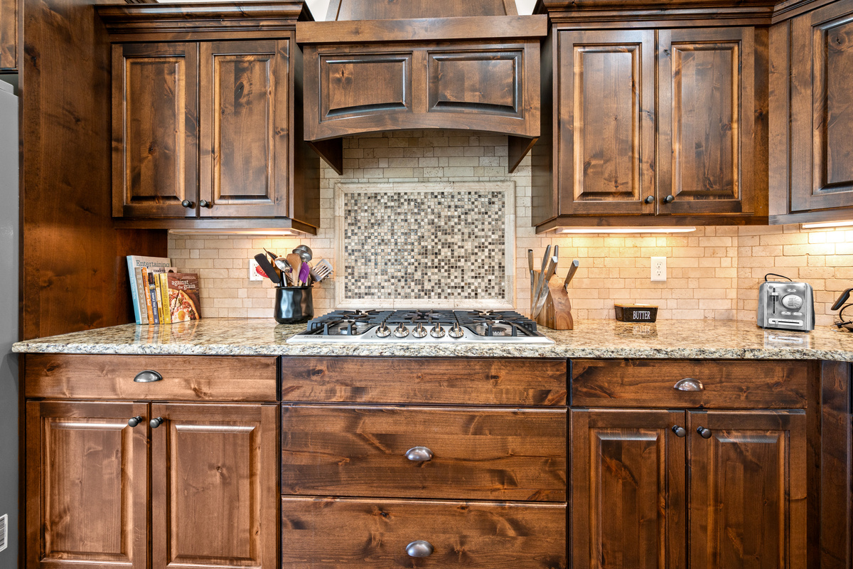 Cook Like a Pro – Featuring a professional gas cooktop, custom range hood, granite countertops, and rich wood cabinetry, this kitchen is designed for everything from quick breakfasts to holiday feasts.