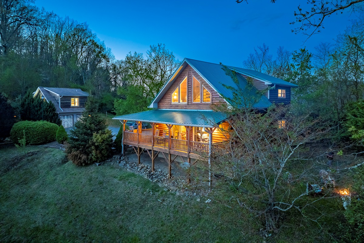 Exterior: Embrace mountain magic in this charming cabin with stunning views and inviting porches!