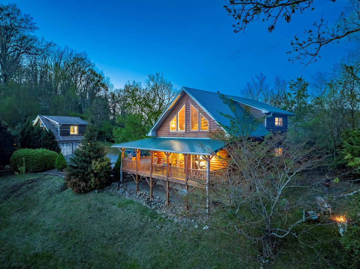 Exterior: Embrace mountain magic in this charming cabin with stunning views and inviting porches!