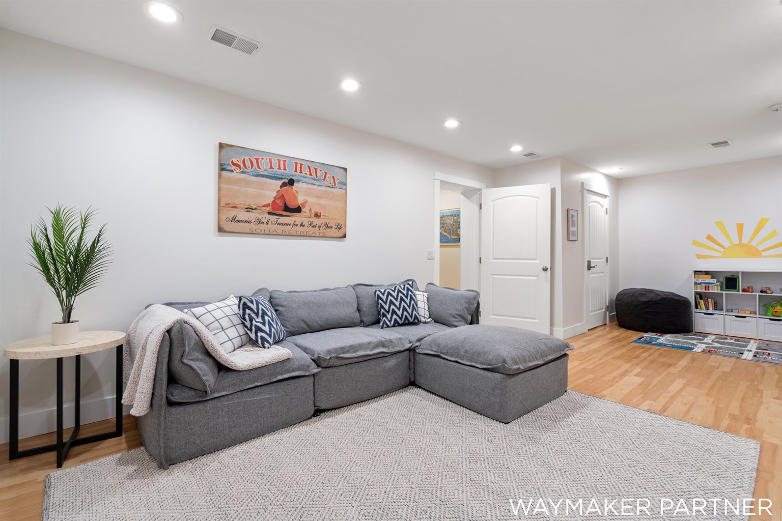 Our comfortable bright living room (3rd shared space) in the basement has a play area for kids and an arcade!