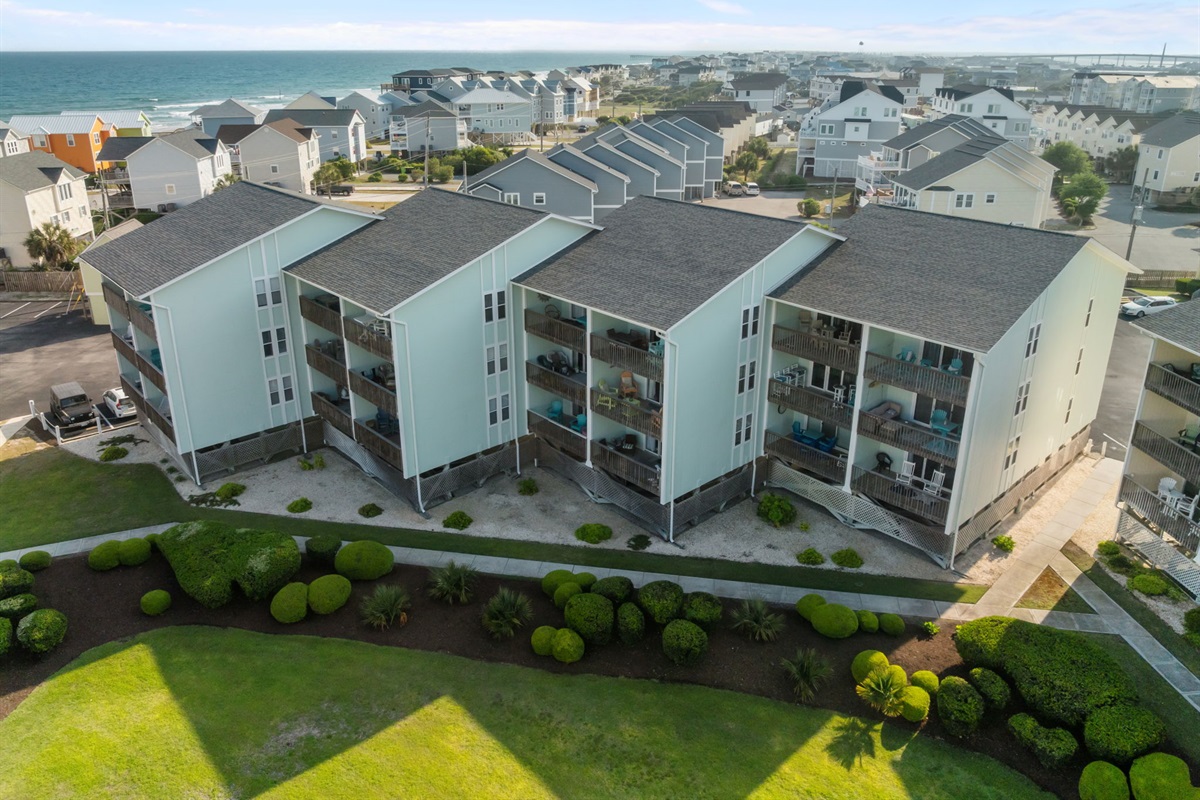 Coastal-style buildings with private balconies just moments from the shoreline