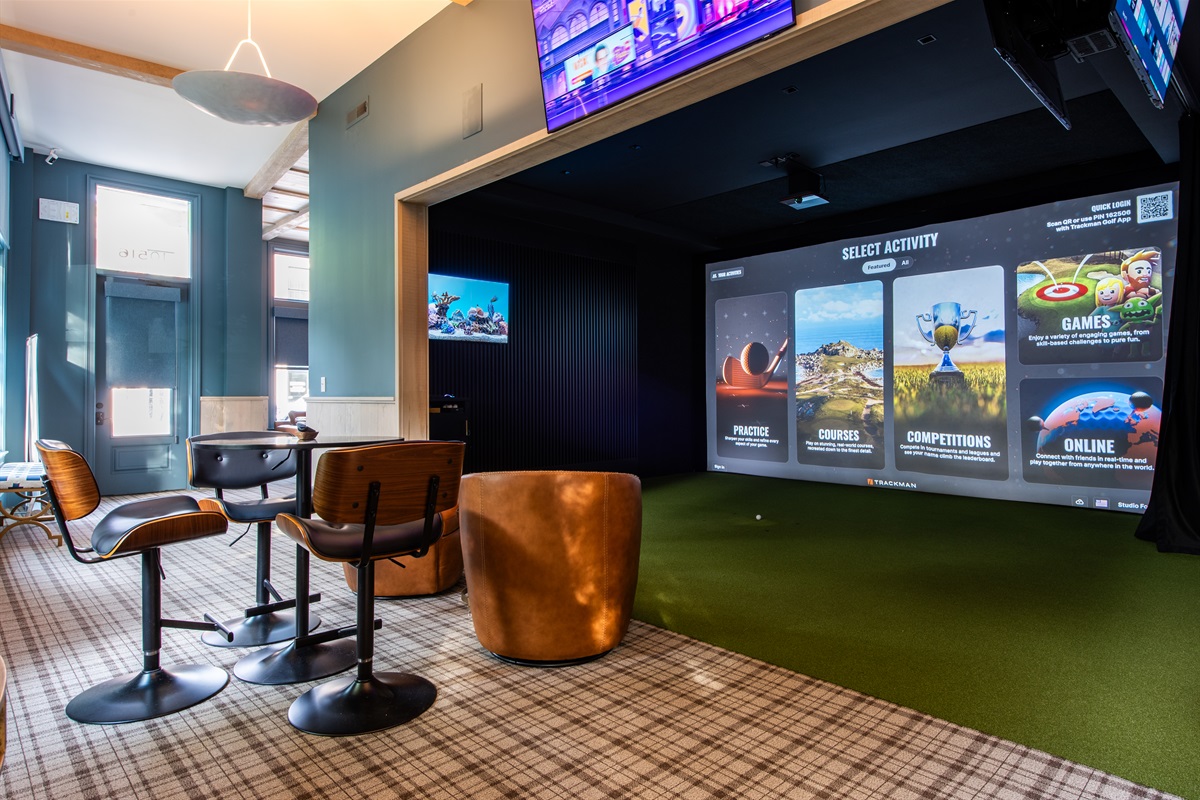 Relax and play in our luxurious golf simulator lounge, an exclusive, paid-access amenity for property guests.