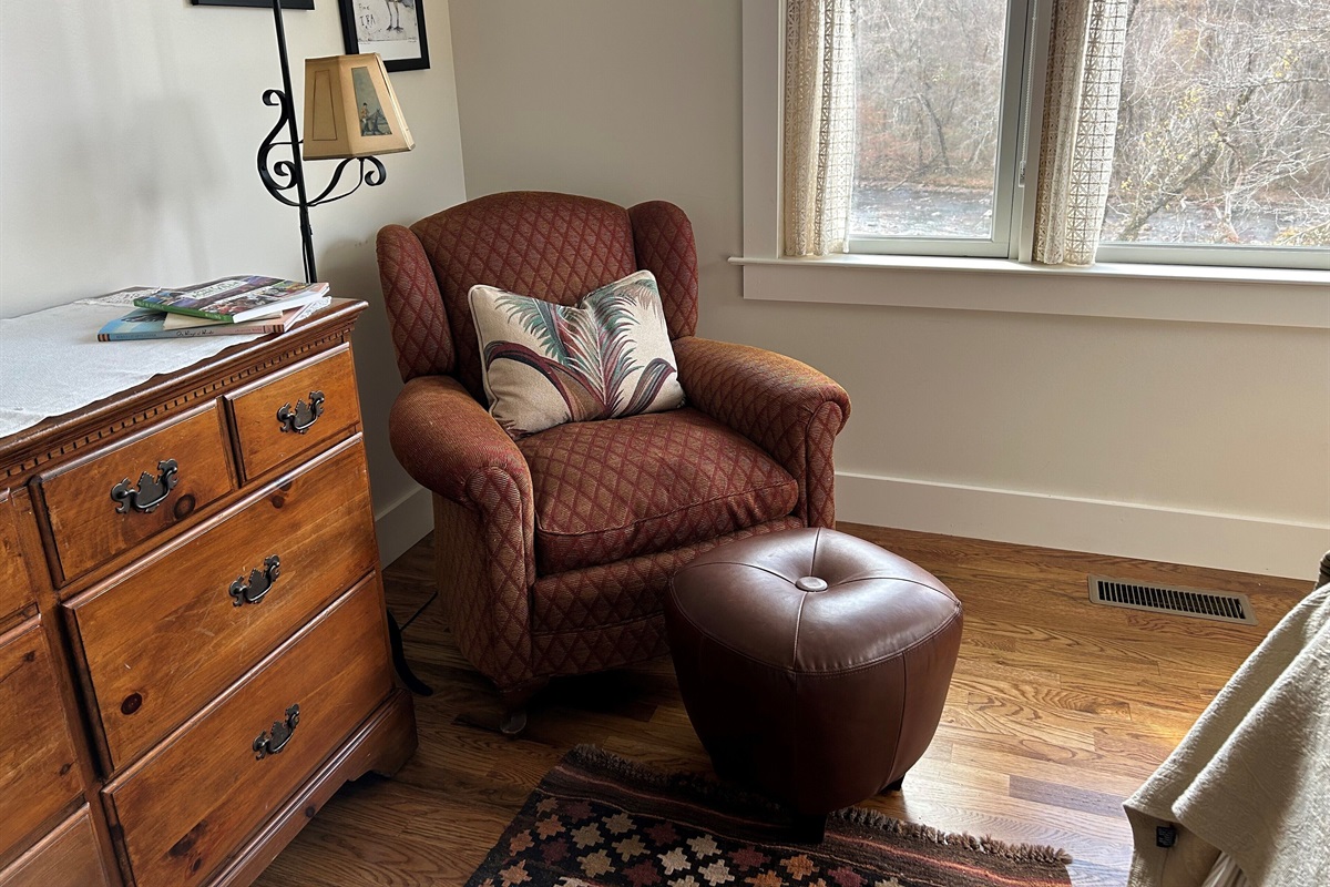 Cozy upstairs chair in queen bedroom with river views