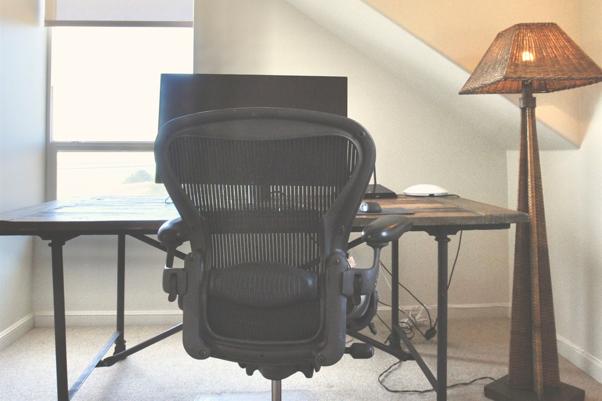 Full desk, office chair and monitor in the office/bedroom, with ocean views