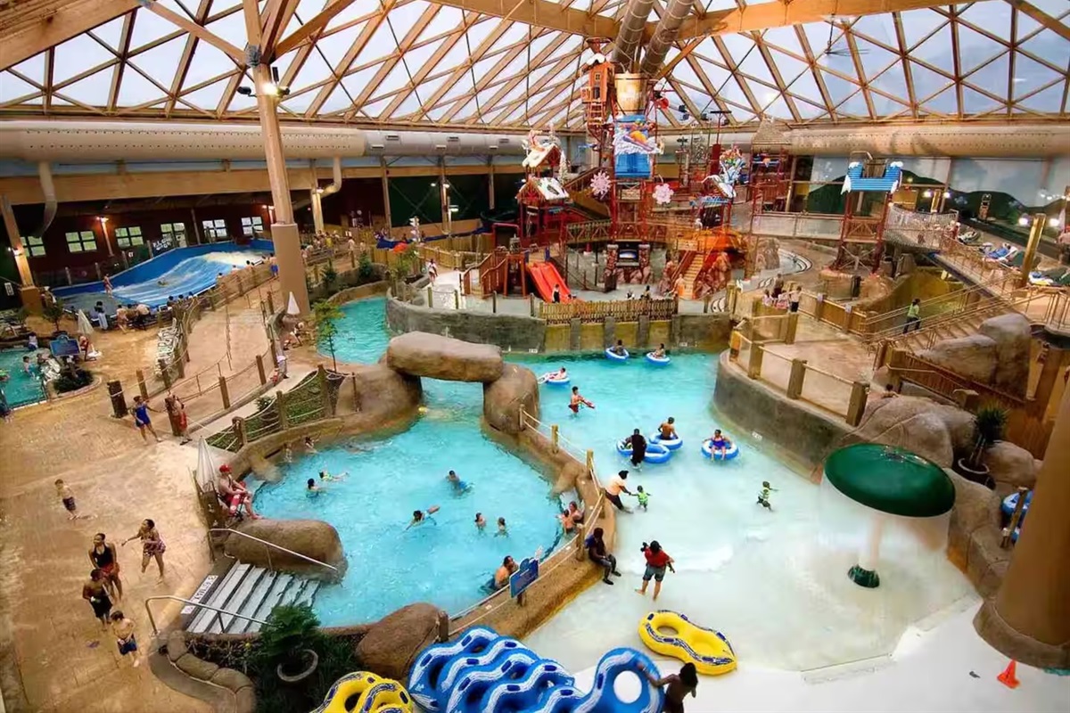 When the weather turns, the indoor waterpark keeps everyone busy — lazy river, rope climb, slides, and a wave pool under a climate-controlled roof.