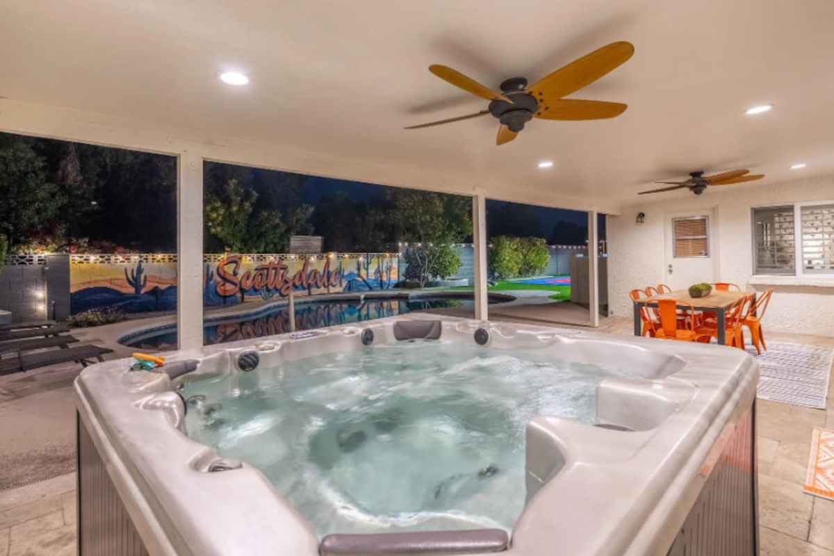 A private hot tub tucked under the patio, poolside views included, made for winding down after a long day in the sun.